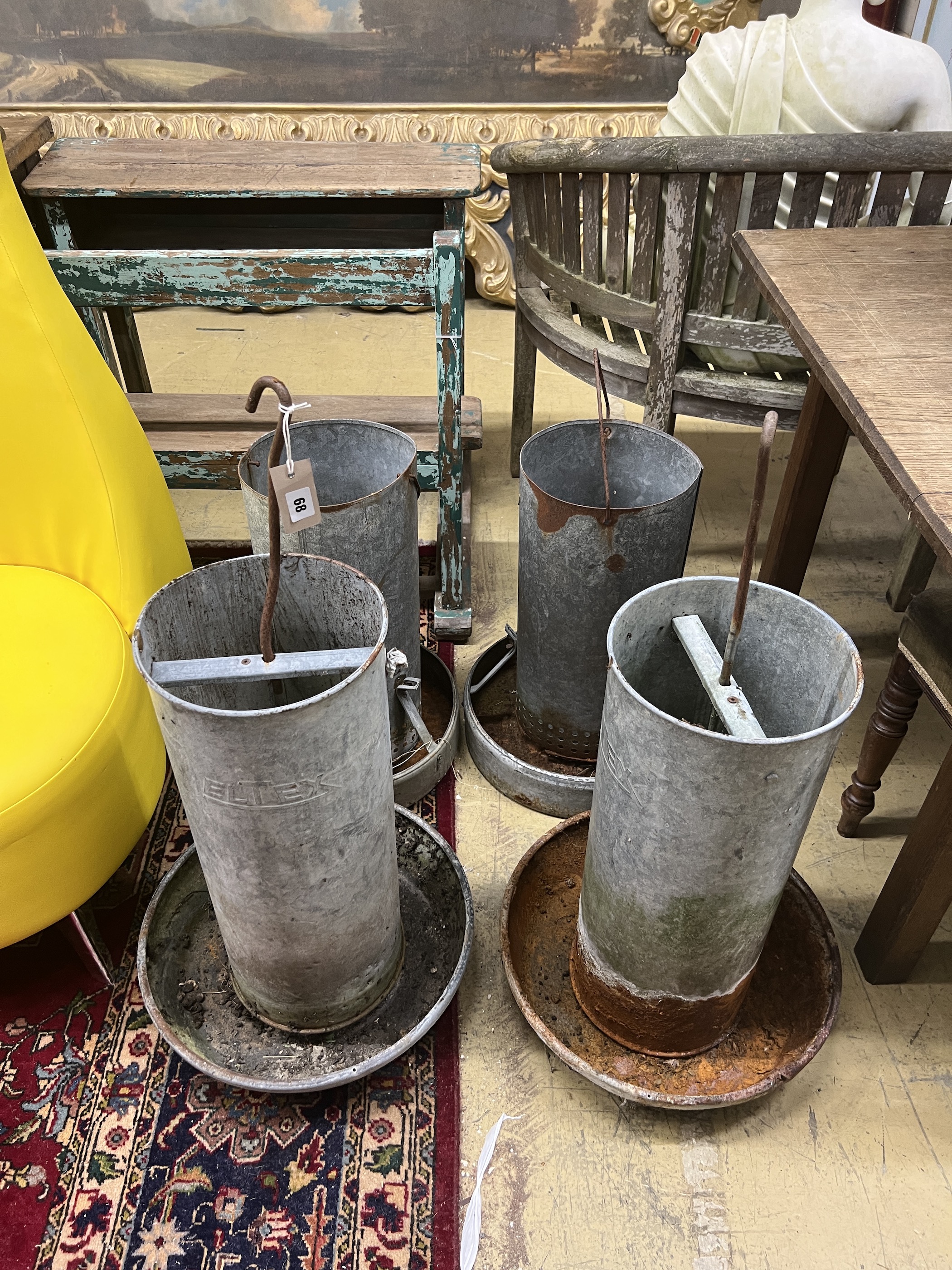 Four vintage galvanised poultry feeders, largest height 62cm
